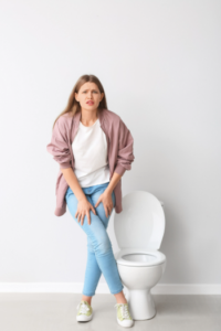A woman experiencing urinary urgency, a common symptom, improved with urinary incontinence physical therapy