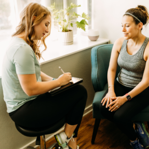 Pelvic floor therapist discussing a patient's history and goals during an initial evaluation session.