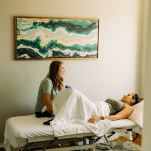 Pelvic floor therapist preparing a patient for an internal examination during an initial evaluation, emphasizing consent and comfort.