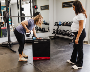 A therapist gives a patient a guided demonstration of an exercise, highlighting proper form and key tips.