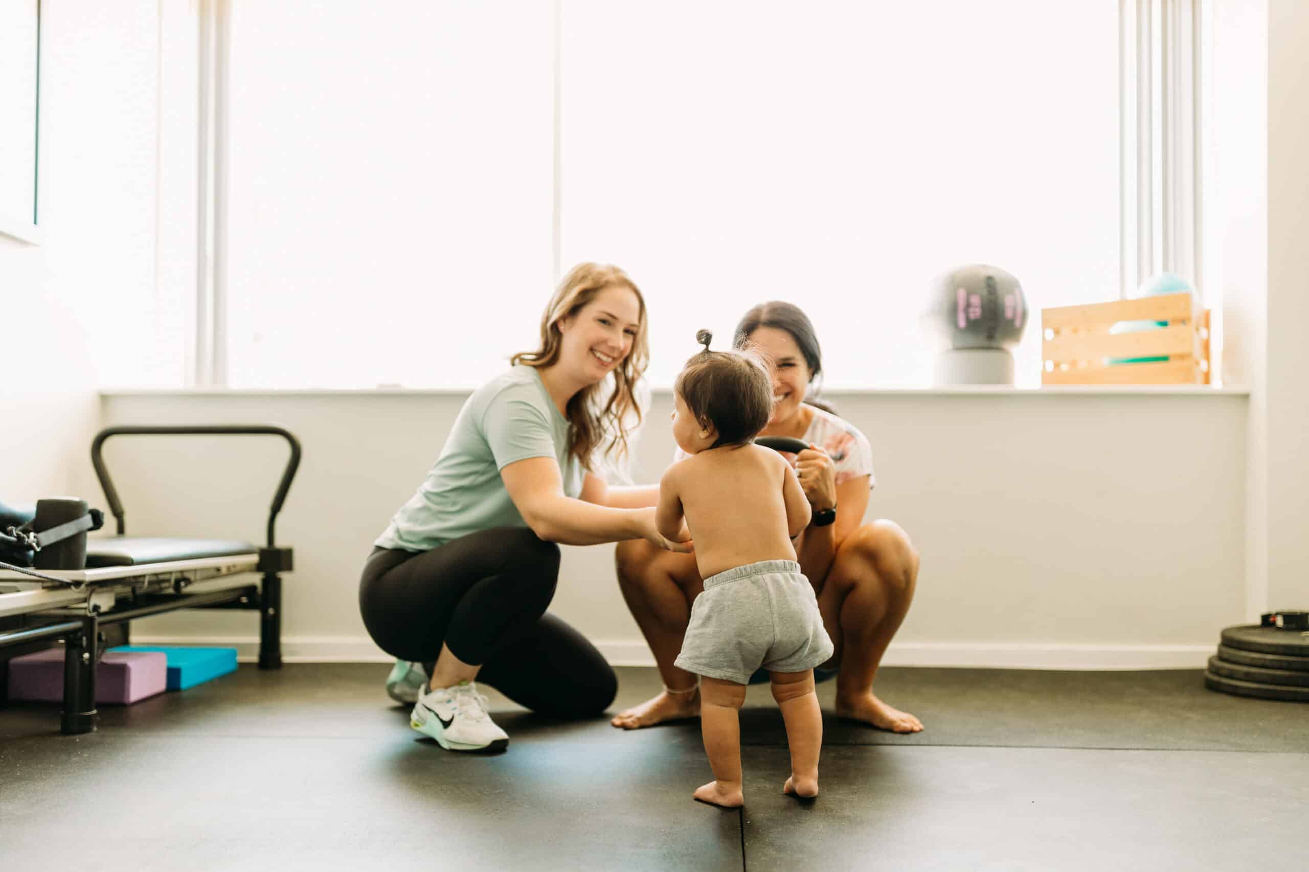 postpartum physical therapy client in San Antonio doing pelvic floor exercises with baby after birth