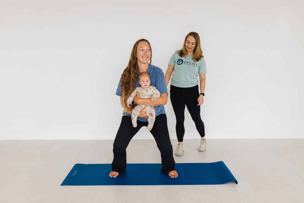 postpartum physical therapy client in San Antonio doing pelvic floor exercises with baby after birth