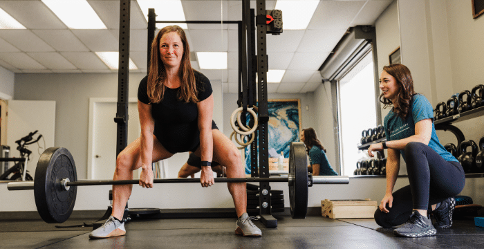 client lifting weights in a pelvic floor physical therapy session at uplift, one of san antonio physical therapy clinics